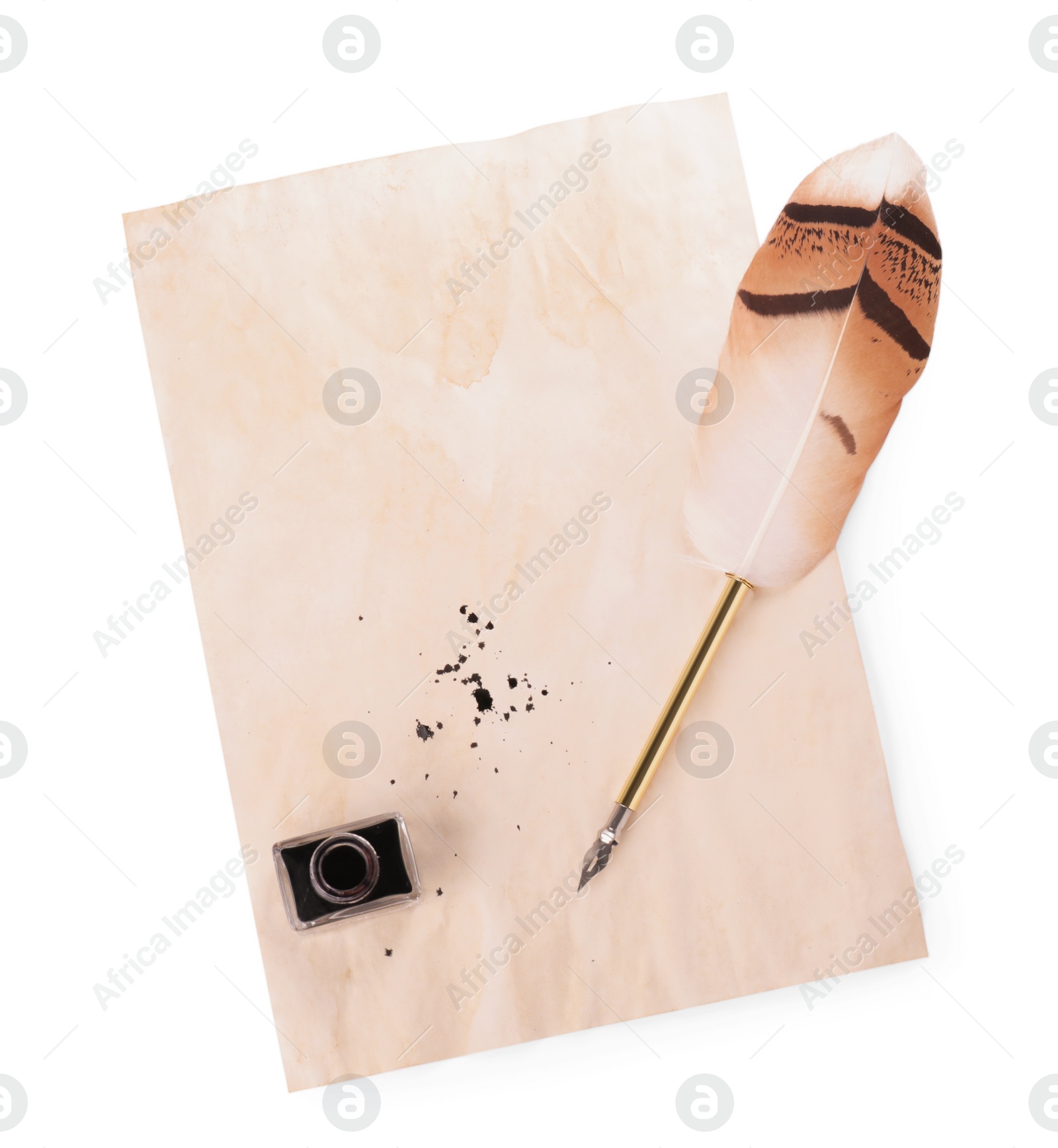 Photo of Parchment with stains of ink, feather pen and inkwell on white background, top view