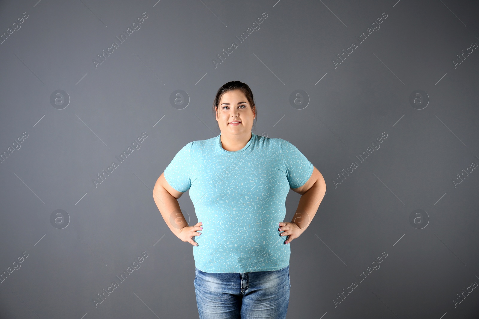 Photo of Portrait of overweight woman on gray background