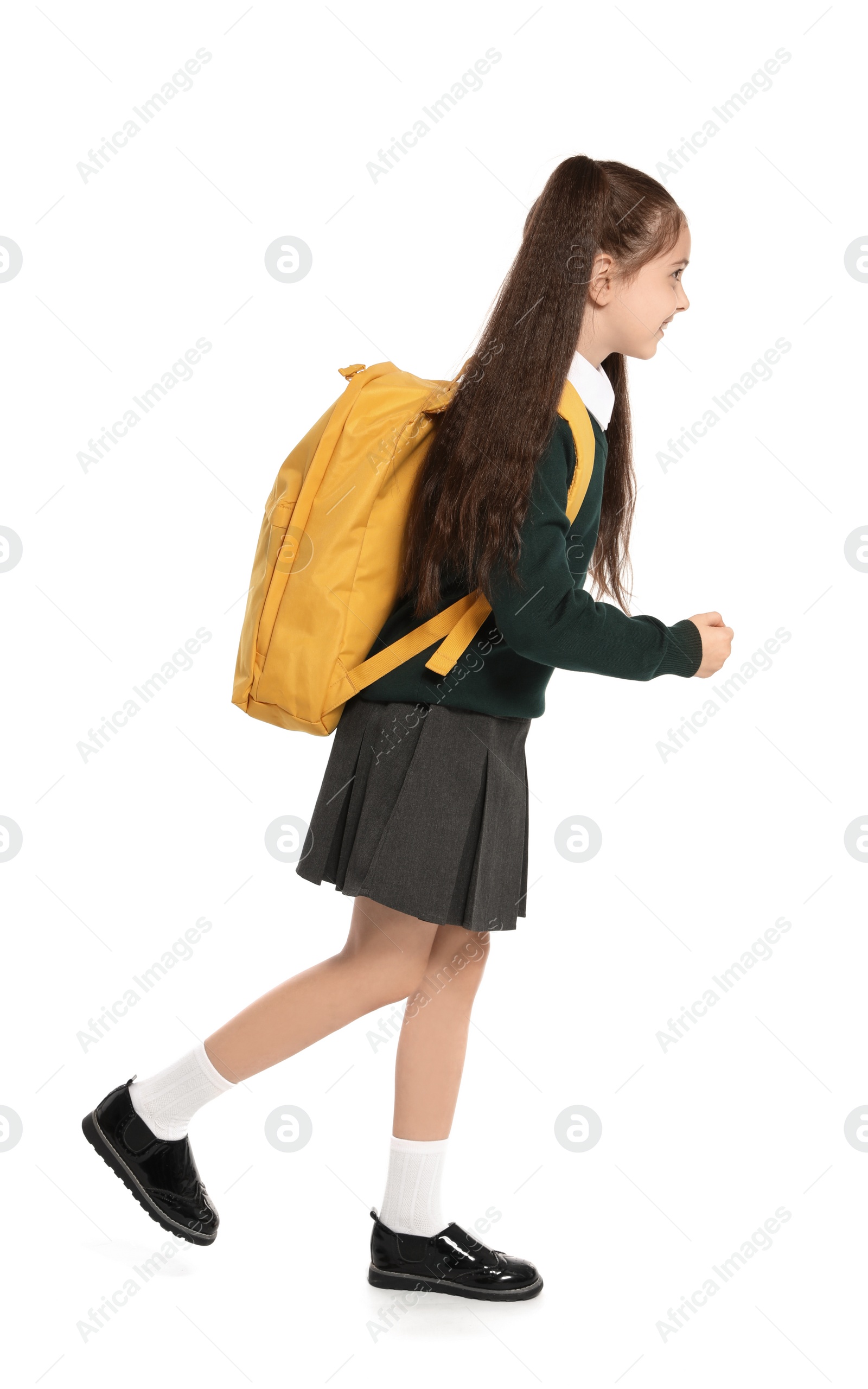 Photo of Little girl in stylish school uniform on white background