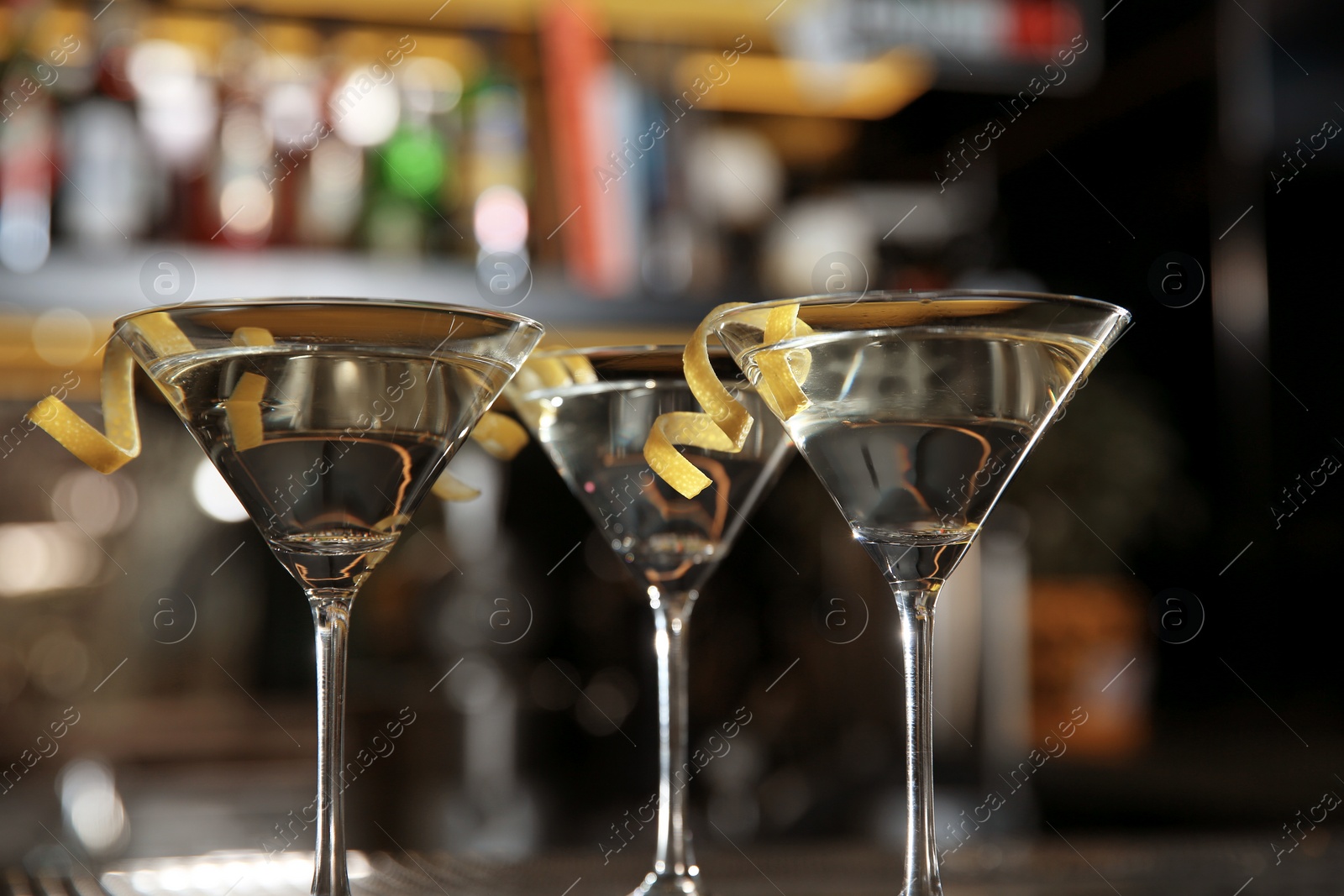 Photo of Glasses of lemon drop martini cocktail in bar