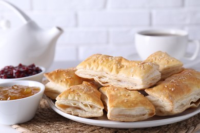 Photo of Delicious puff pastry served on white table, closeup