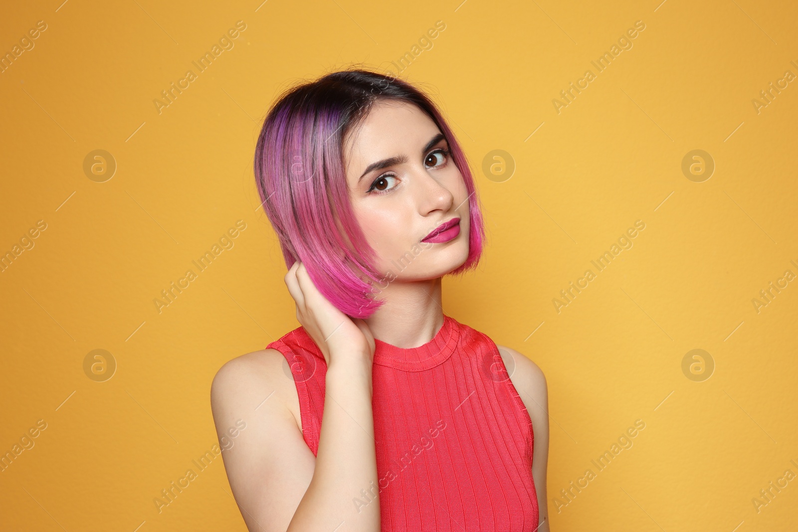 Photo of Young woman with trendy hairstyle against color background