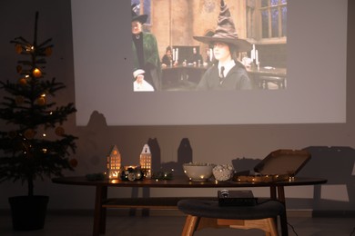 Photo of Lviv, Ukraine – January 24, 2023: Video projector screen displaying Harry Potter And The Philosopher’s Stone movie in cozy room