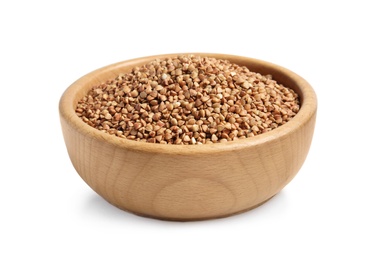 Bowl with uncooked buckwheat on white background