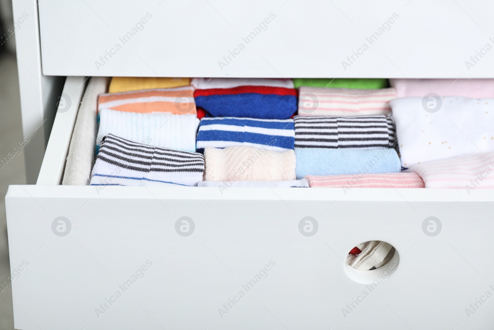 Photo of Wardrobe drawer with many child socks, closeup