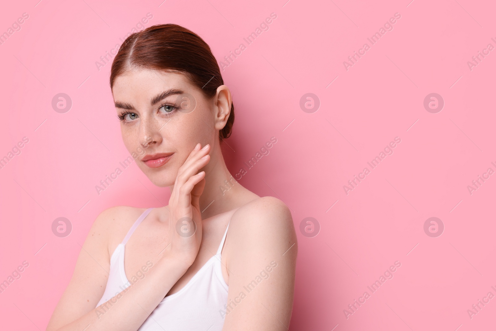 Photo of Portrait of beautiful woman on pink background. Space for text