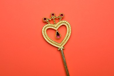 Beautiful golden magic wand on coral background, top view