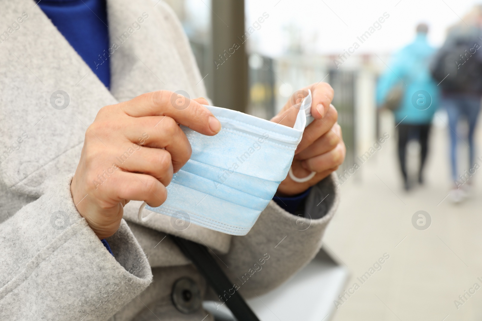 Photo of Woman with protective face mask on city street, closeup