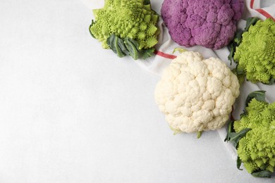 Photo of Different fresh cabbages on white table, flat lay. Space for text