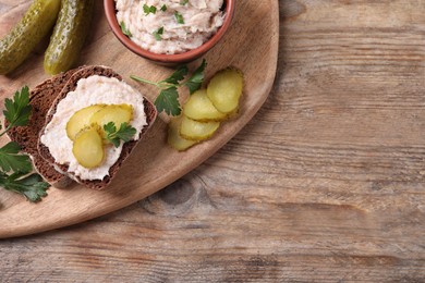 Sandwich with delicious lard spread and pickles on wooden table, flat lay. Space for text