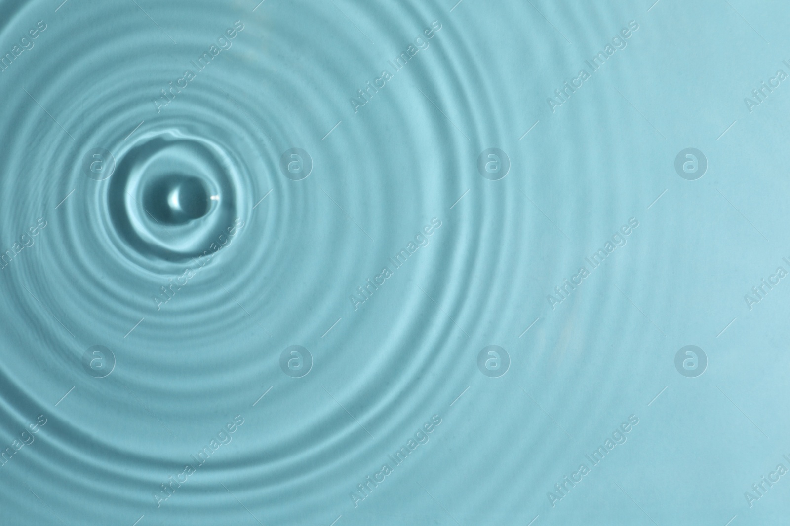 Photo of Closeup view of water with circles on turquoise background