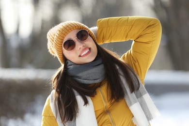 Photo of Portrait of beautiful young woman with sunglasses on winter day outdoors