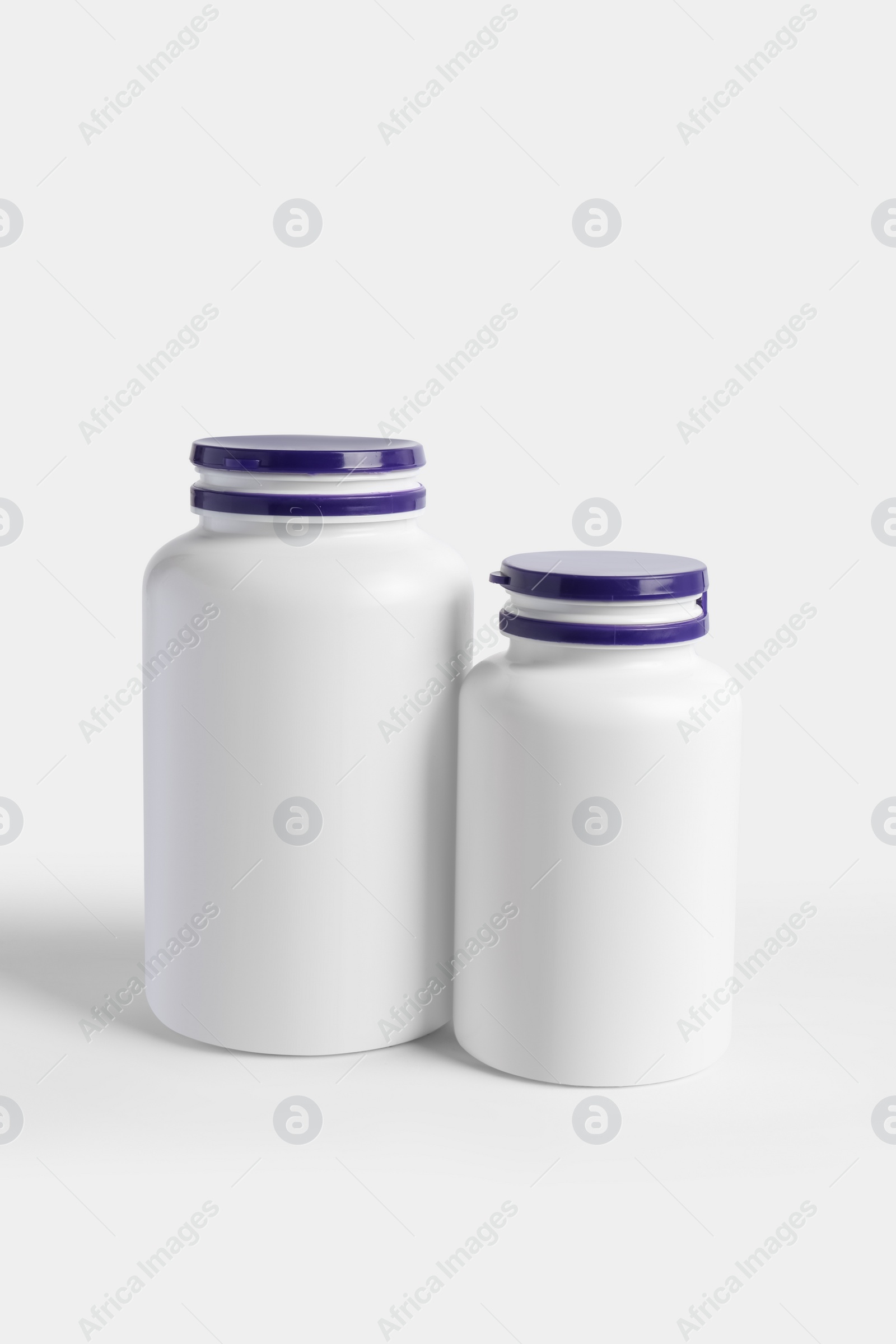 Photo of Closed plastic medicine bottles on white background. Medicament