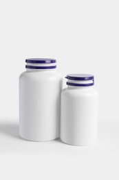 Closed plastic medicine bottles on white background. Medicament