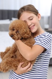 Little child with cute puppy at home. Lovely pet