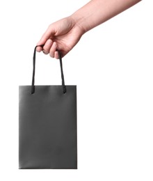 Woman holding paper shopping bag on white background, closeup