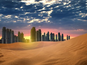Image of Sandy desert and silhouette of city on horizon at sunset