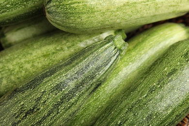 Fresh ripe green zucchini as background, closeup