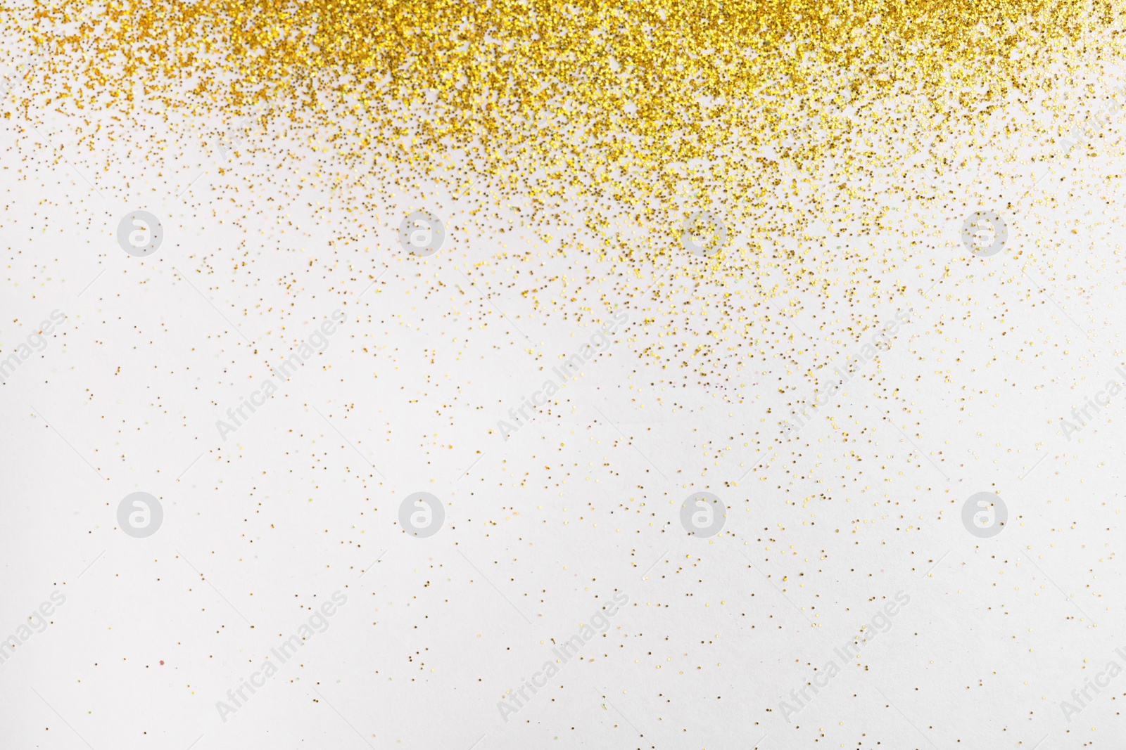 Photo of Golden glitter on white background, top view