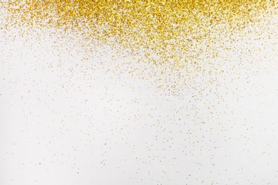 Photo of Golden glitter on white background, top view