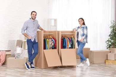 Young couple near wardrobe boxes at home