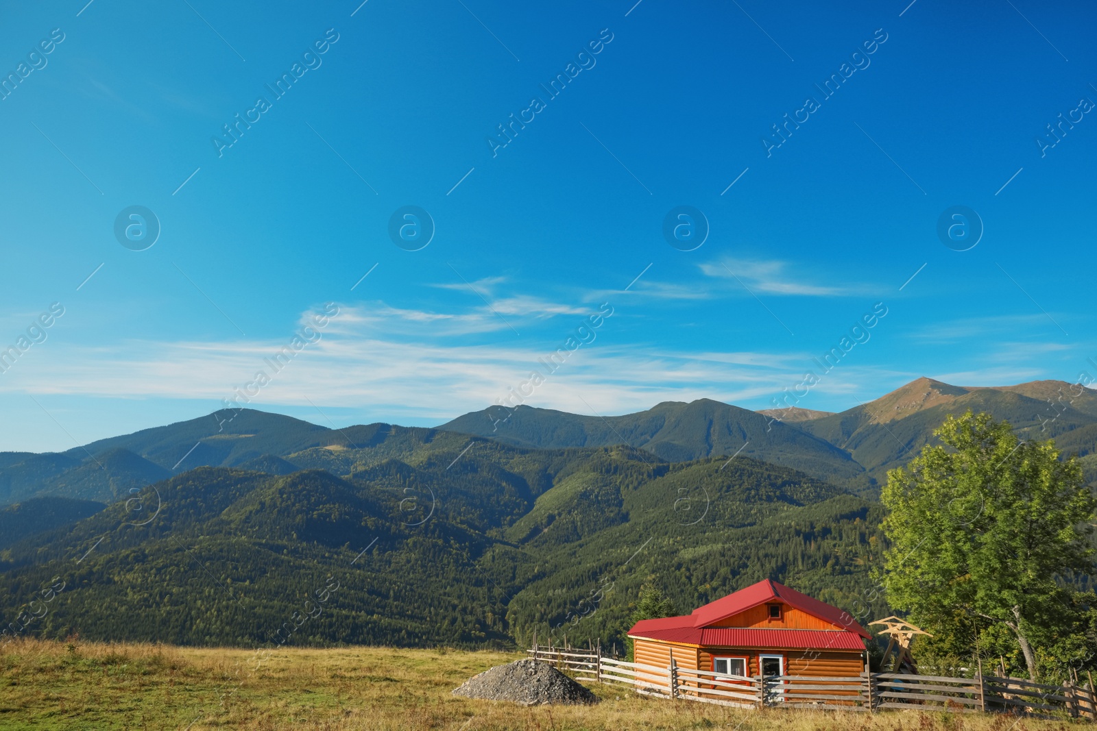 Photo of Picturesque view of sky with clouds over beautiful house in mountains