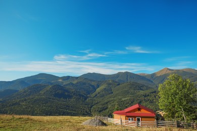 Picturesque view of sky with clouds over beautiful house in mountains