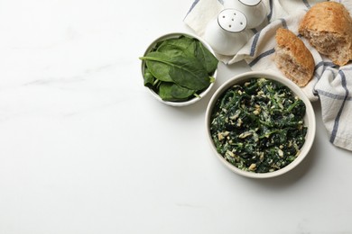 Photo of Tasty spinach dip with eggs in bowl and bread on white table, flat lay. Space for text