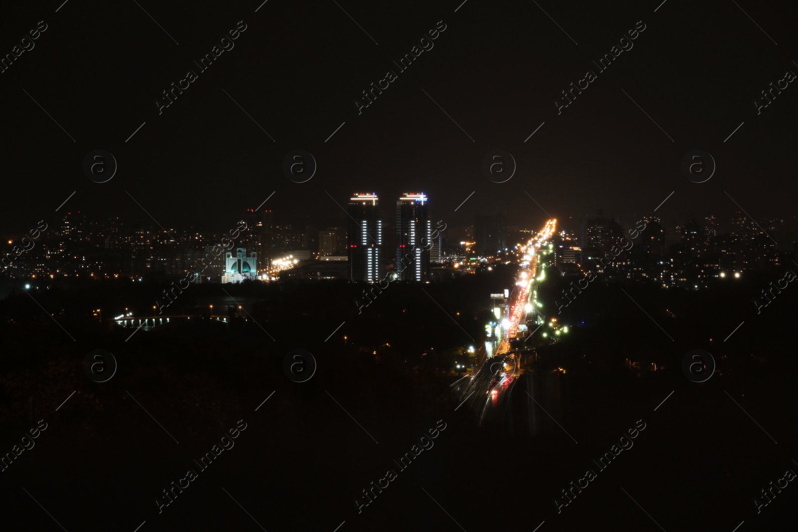 Photo of KYIV, UKRAINE - MAY 22, 2019: View of night city with apartment complex Soniachna Riviera and Metropolitan Andrey Sheptytsky Street