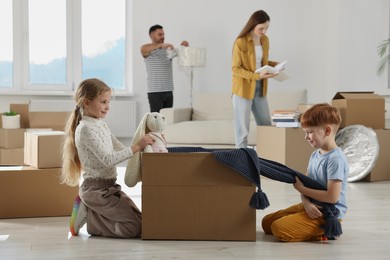 Photo of Happy family settling into new house and unpacking boxes. Moving day
