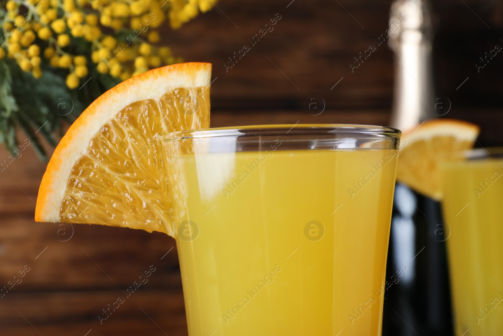 Photo of Glass of Mimosa cocktail with garnish, closeup