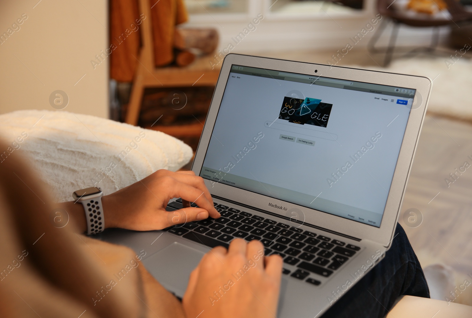 Photo of MYKOLAIV, UKRAINE - OCTOBER 31, 2020: Woman using Google search engine on MacBook Air laptop indoors, closeup