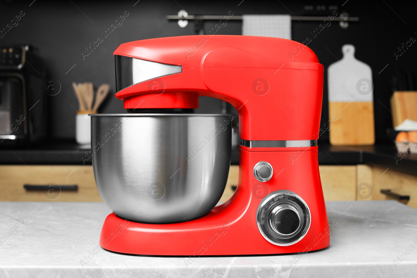 Photo of Modern stand mixer on table in kitchen. Home appliance