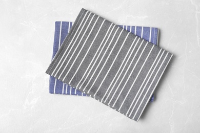 Striped fabric table napkins on light background, top view