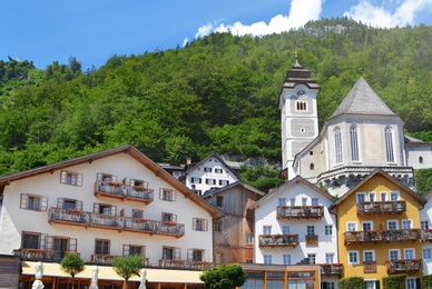 Picturesque view of town with beautiful buildings near mountain forest