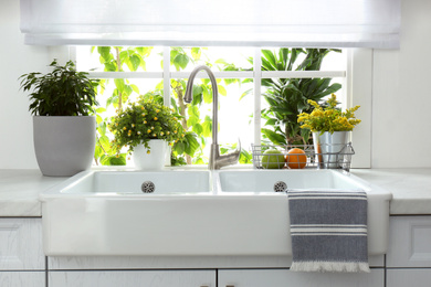 Beautiful white sink near window in modern kitchen