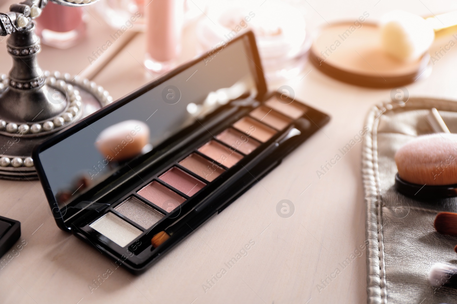 Photo of Eye shadow palette with mirror on dressing table