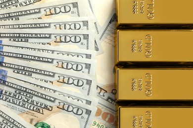 Photo of Shiny gold bars on dollar banknotes, flat lay. Space for text