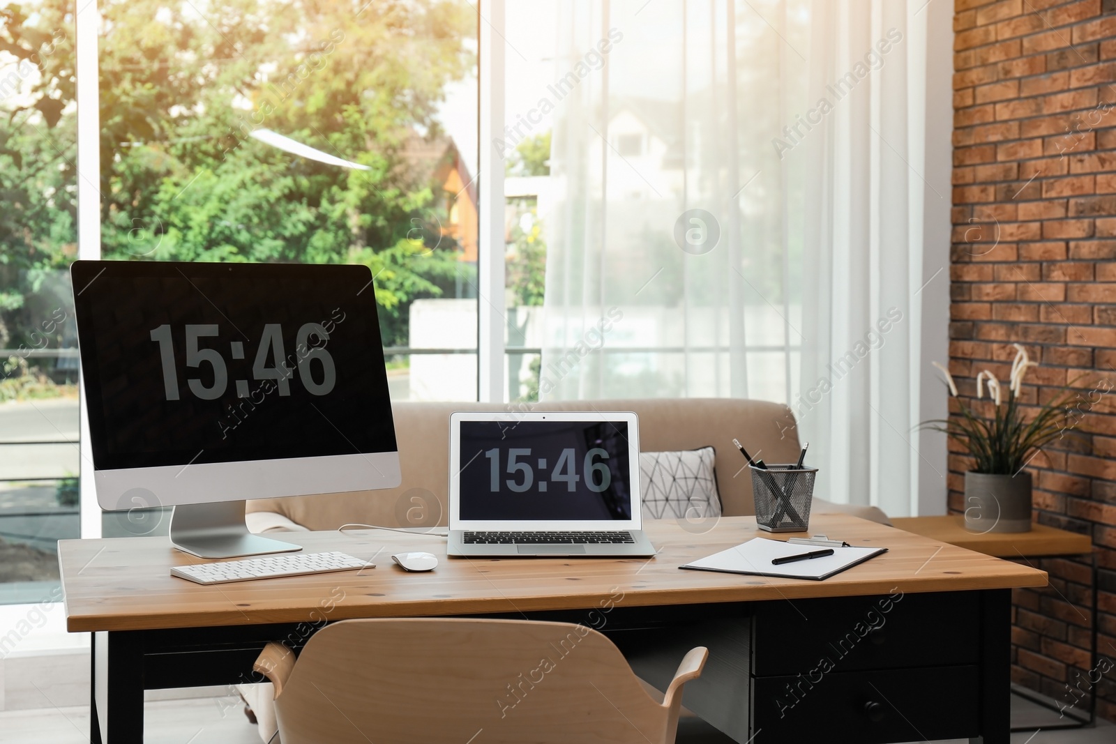 Photo of Stylish workplace with modern computers in home office