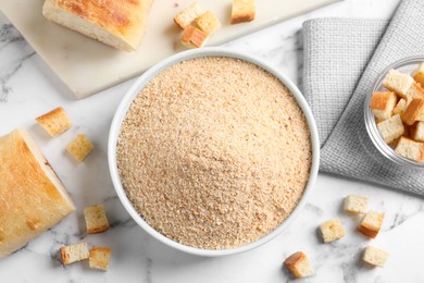 Photo of Fresh breadcrumbs on white marble table, flat lay