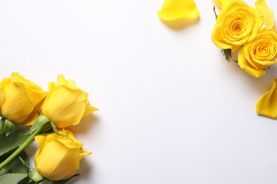 Photo of Beautiful yellow roses on white background, flat lay. Space for text