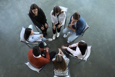Photo of Psychotherapist working with patients in group therapy session, top view