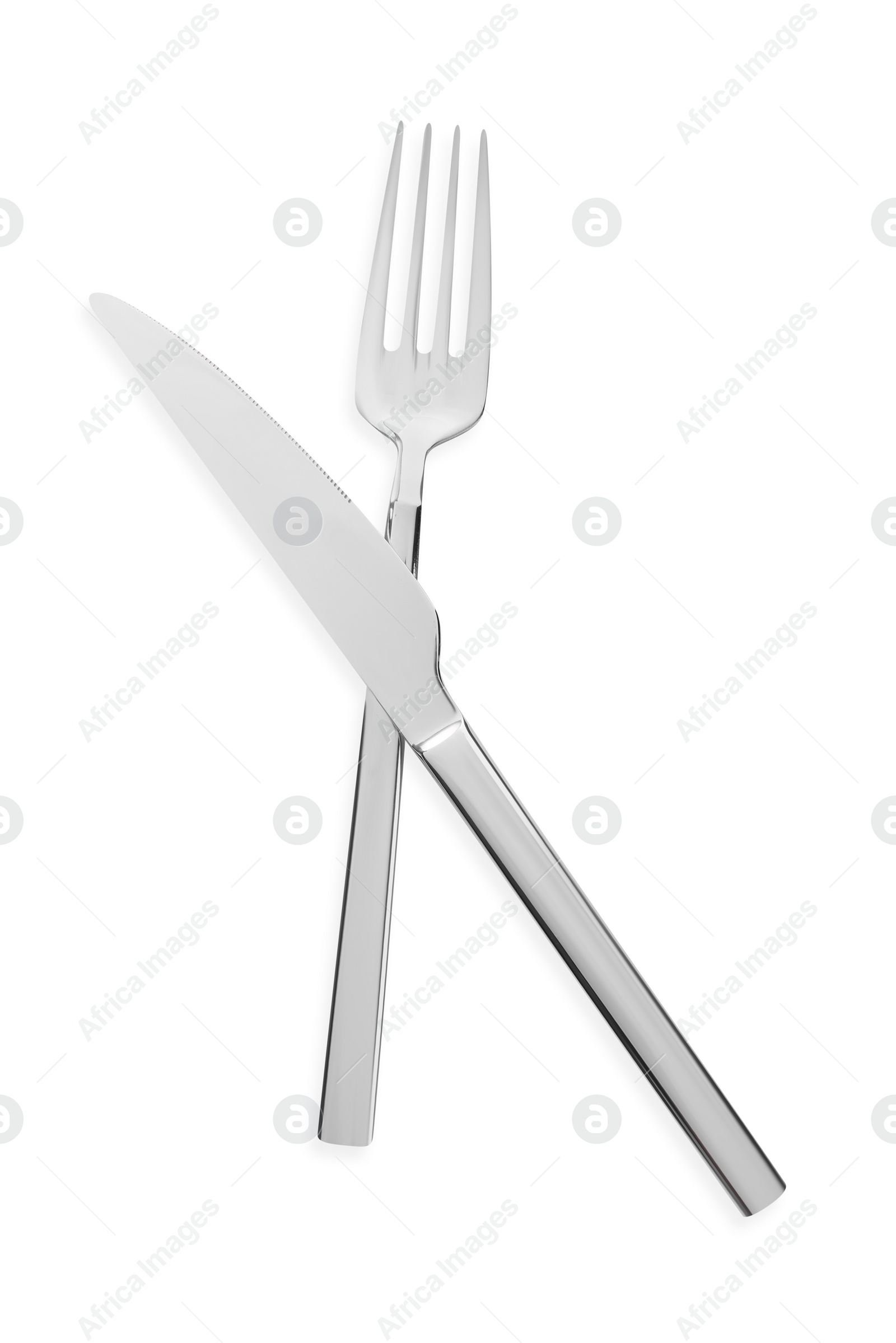 Photo of Fork and knife isolated on white, top view. Stylish shiny cutlery set