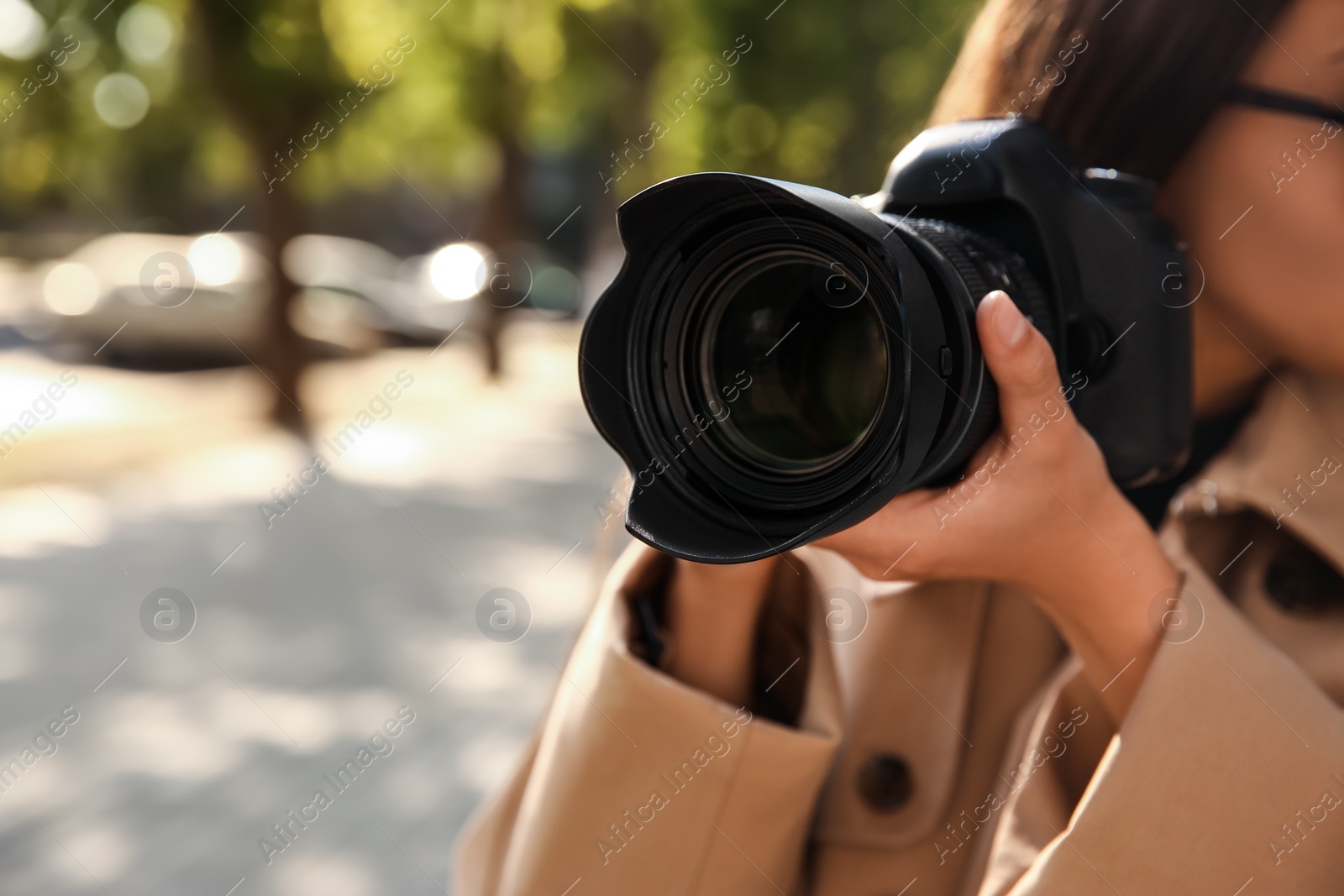 Photo of Private detective with camera spying outdoors, closeup