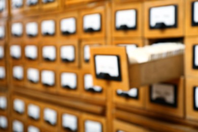 Blurred view of library card catalog drawers, space for text