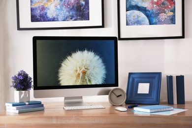 Photo of Modern workplace interior with computer on table