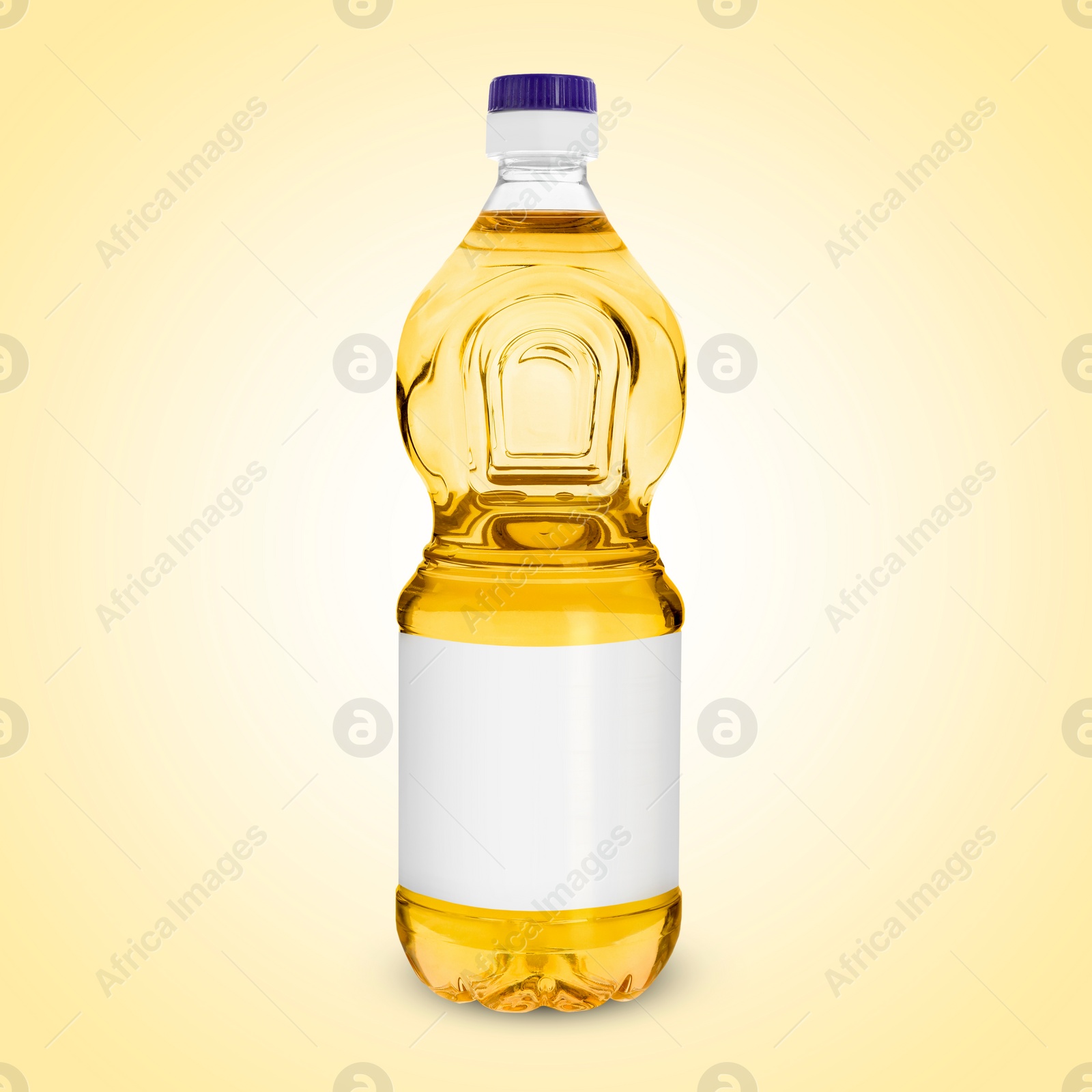 Image of Cooking oil in plastic bottle with empty label on light yellow background. Mockup for design