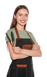 Portrait of happy hairdresser with combs on white background