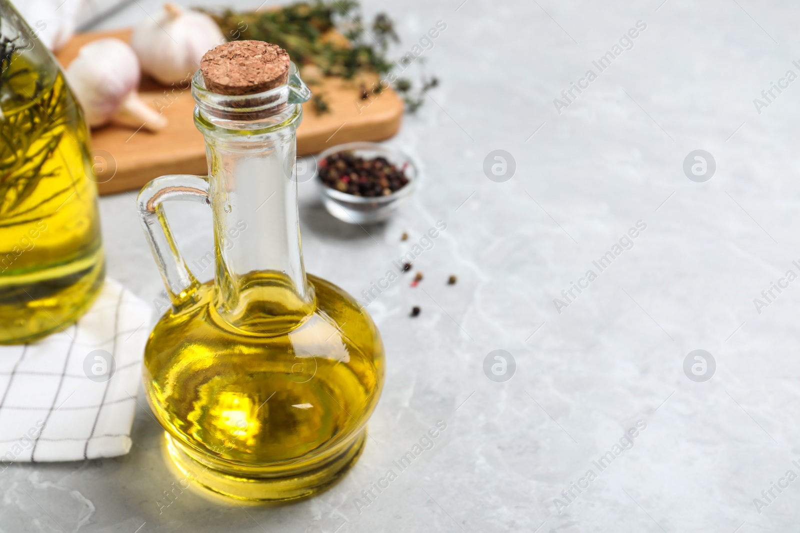 Photo of Cooking oil on grey marble table. Space for text