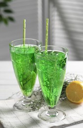 Glasses of homemade refreshing tarragon drink on table